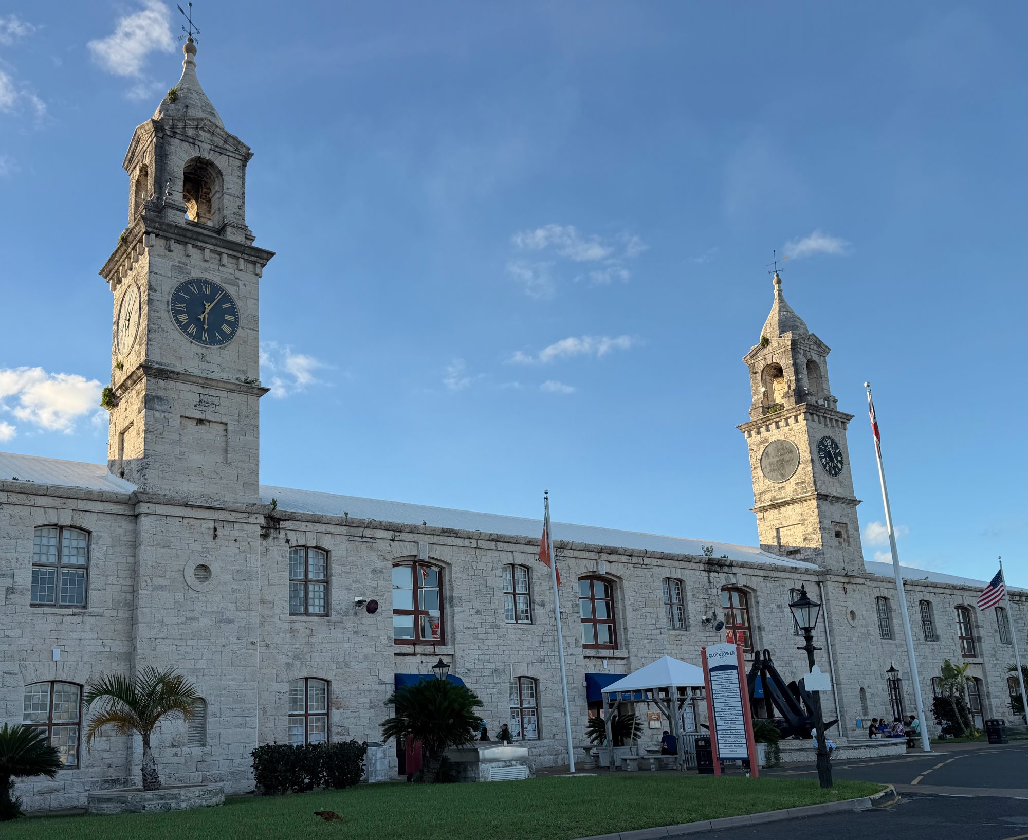 The limestone Clocktower building with its two clock towers at the Royal Naval Dockyard, Bermuda, under a blue sky