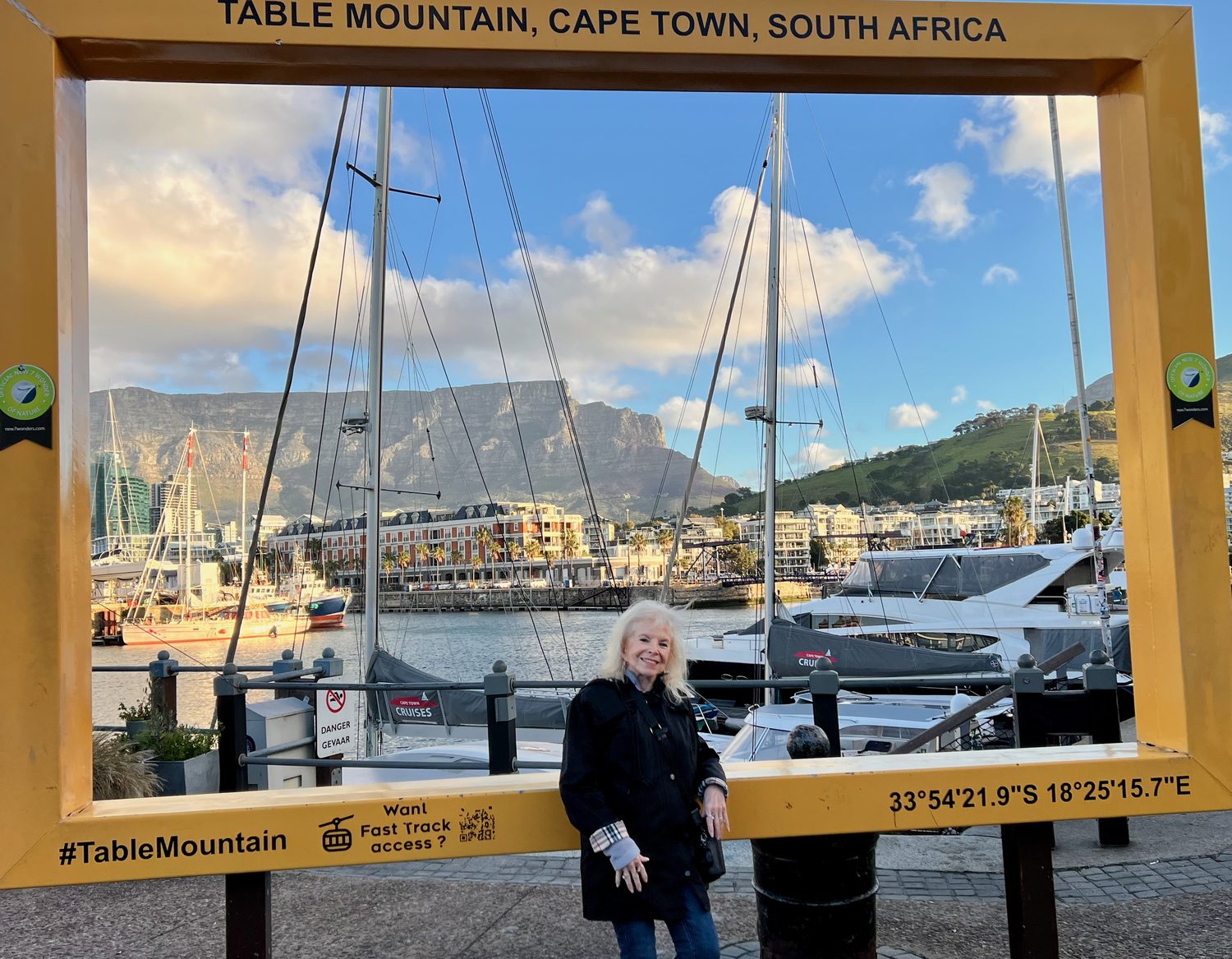 Dana Wallace Cash at the waterfront, framed against the harbour with Table Mountain behind
